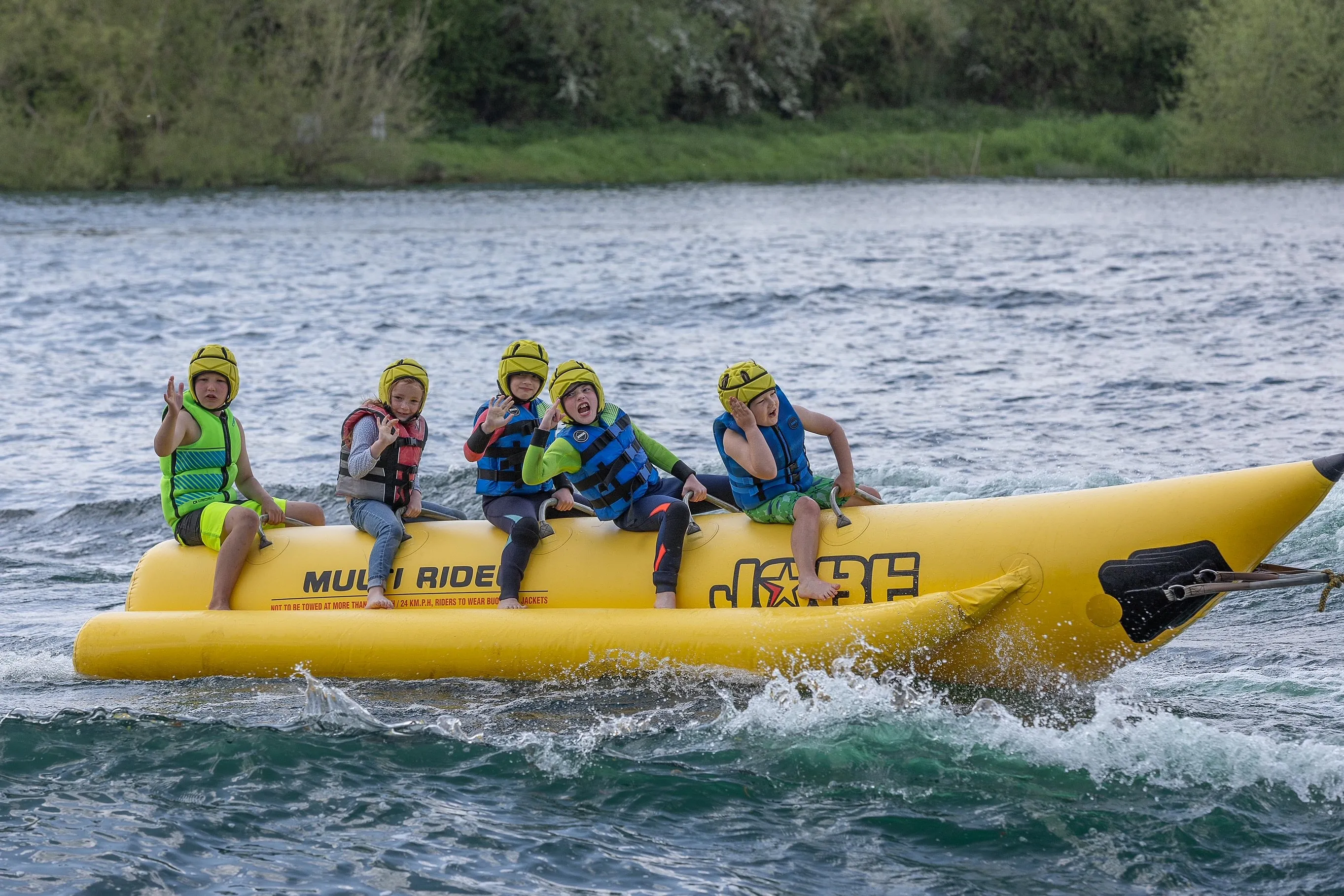 children having fun on a banana inflatable ride